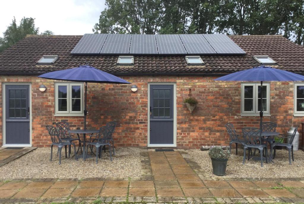 a house with solar panels on top of it at Mowbray Stable Cottages in Thirsk