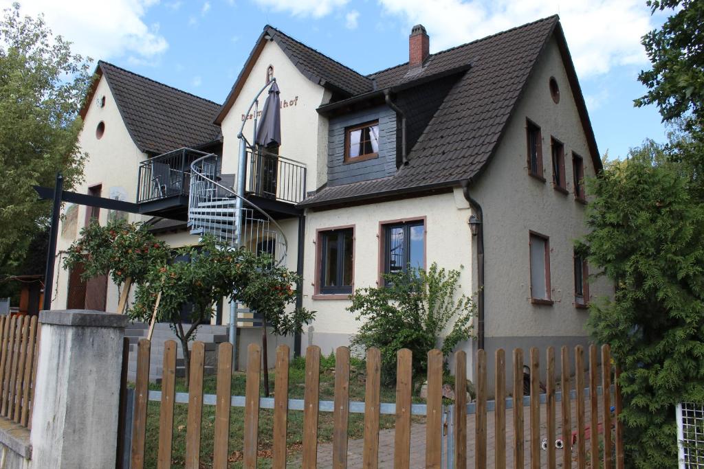 een wit huis met een houten hek bij Dreimädelhof in Rüdesheim am Rhein