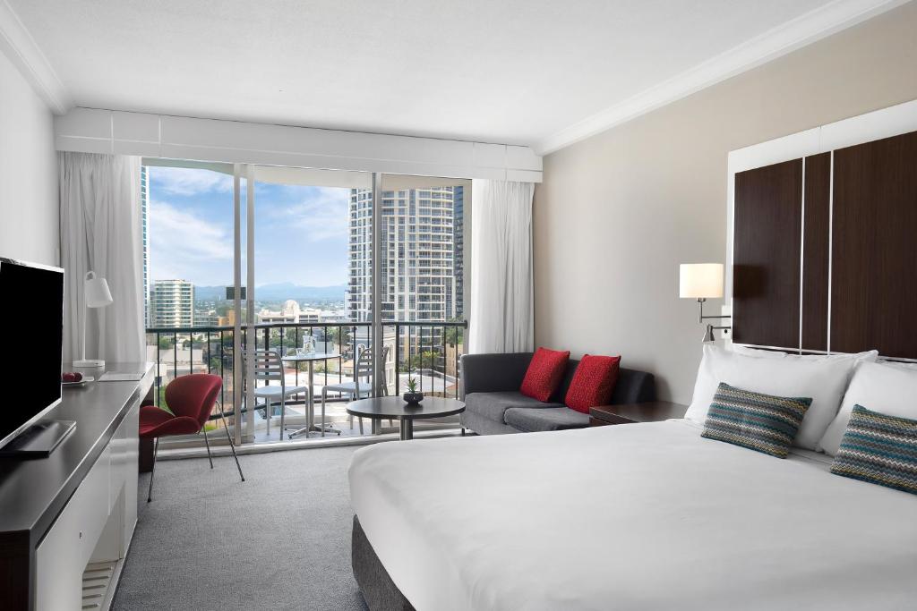 a hotel room with a large bed and a large window at Mantra on View Hotel in Gold Coast