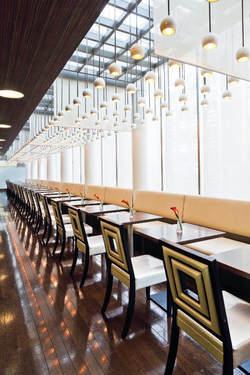 a long row of tables and chairs in a restaurant at Citadines Central Shinjuku Tokyo in Tokyo