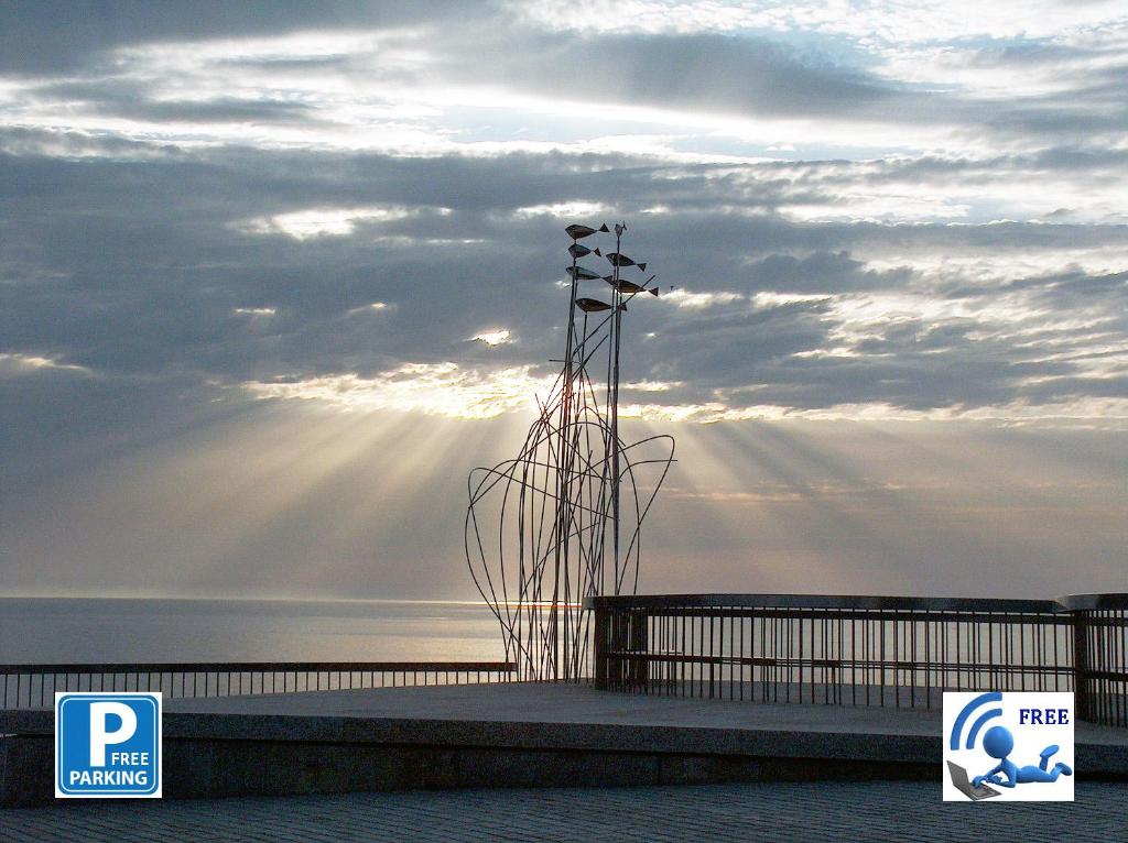 a group of lights on a pier with the sunrays at Vistas 180º al mar/puesta de sol/Free Wifi-parking in Bakio