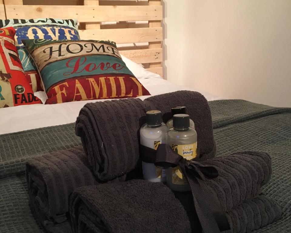 a bed with two towels and two bottles on it at Yairbrig Holiday in Galashiels