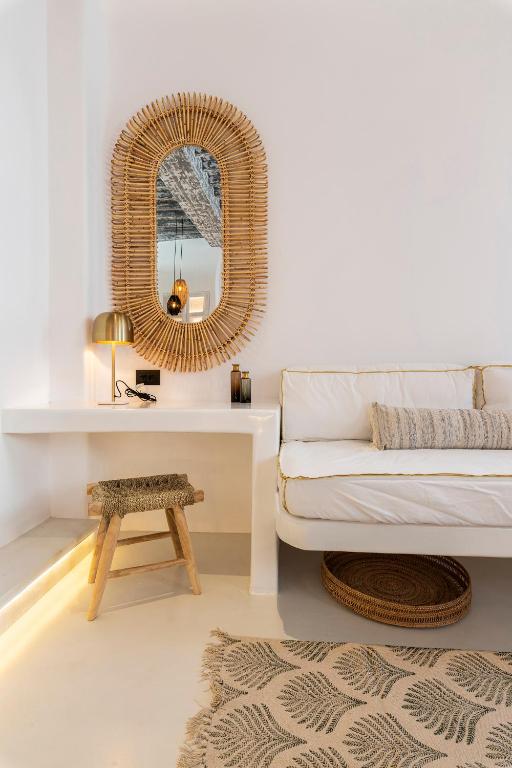 a living room with a white couch and a mirror at The TownHouse Mykonos in Mýkonos City