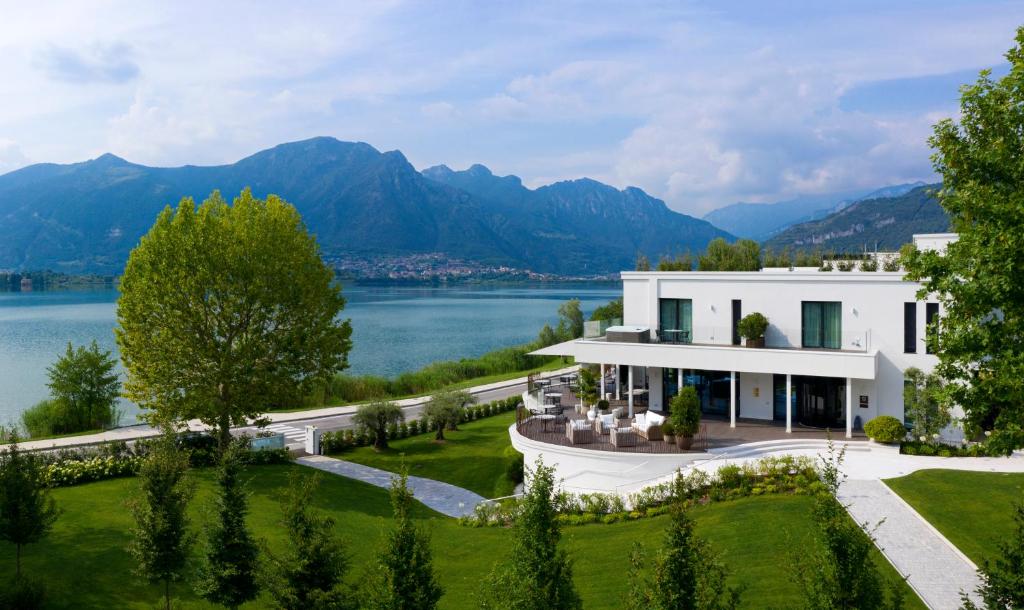 an aerial view of a house with a lake and mountains at Bianca Relais in Oggiono