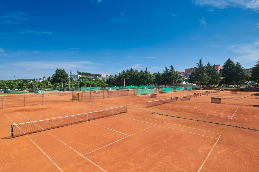 a tennis court with several tennis nets on it at Hotel Zorna Plava Laguna in Poreč