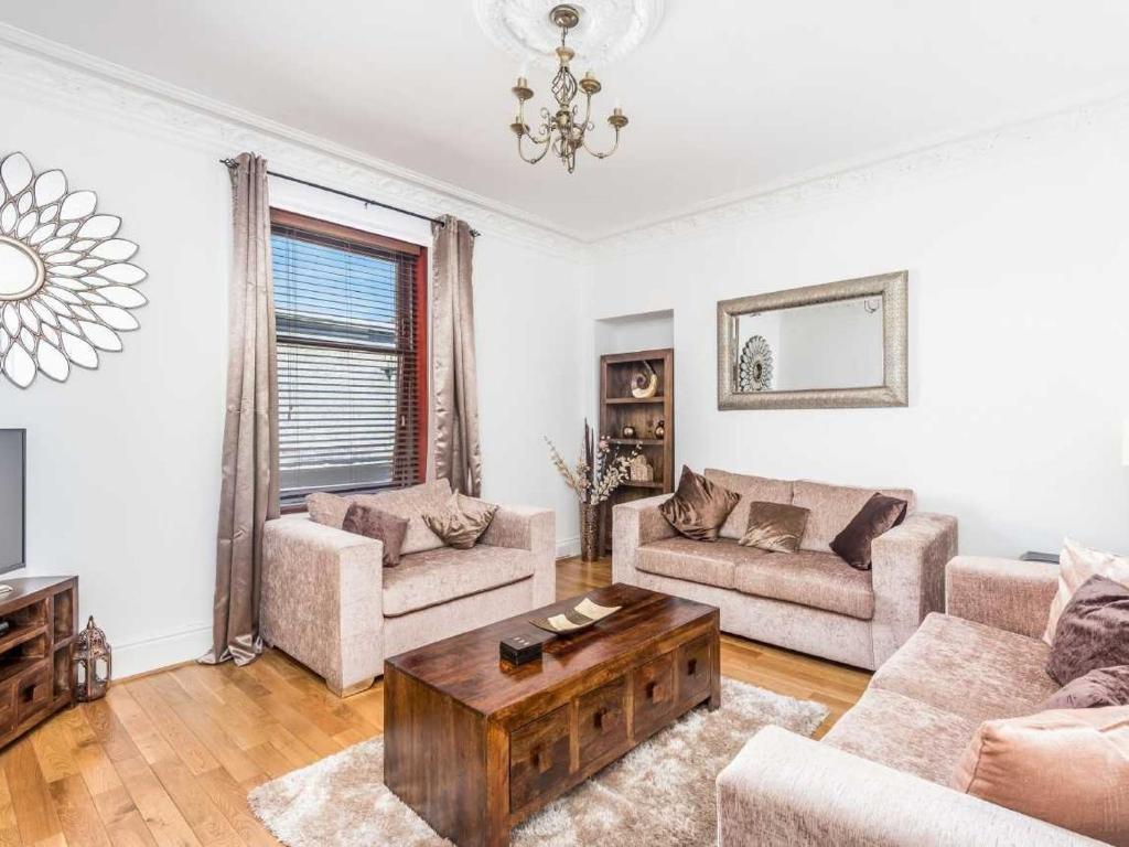 a living room with a couch and a coffee table at Casa Fresa - Ferry House in Broughty Ferry