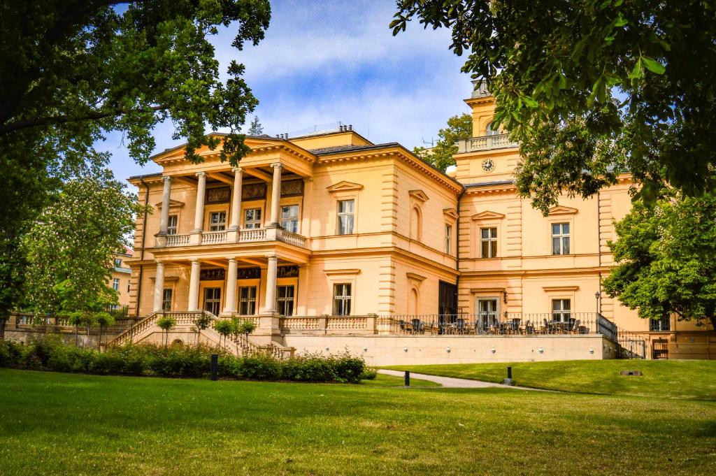 a large building with a lawn in front of it at Vila Lanna in Prague