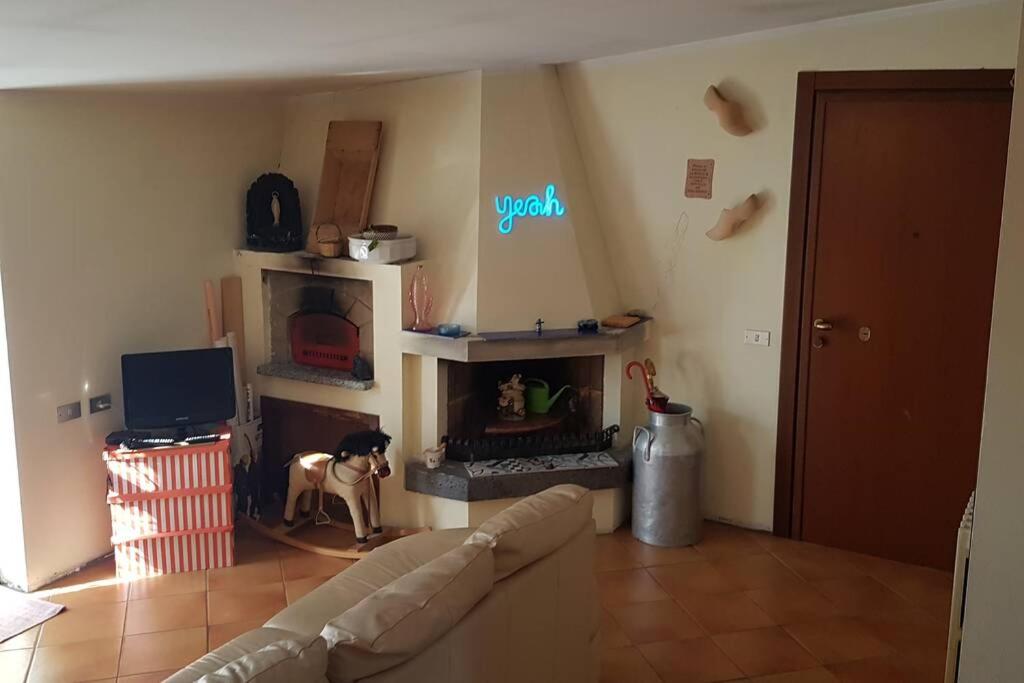 a living room with a couch and a fireplace at DA MARIA - MARIA'S FLAT _ MILANO BOVISA POLITECNICO in Milan