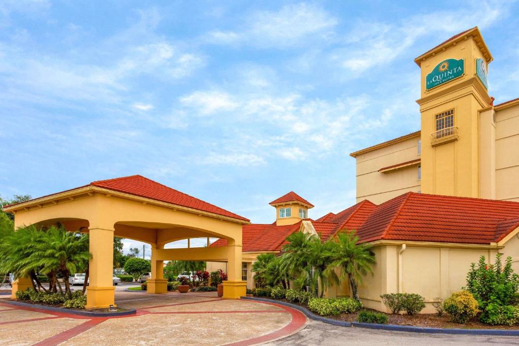 a hotel with a building with a red roof at La Quinta by Wyndham Lakeland West in Lakeland