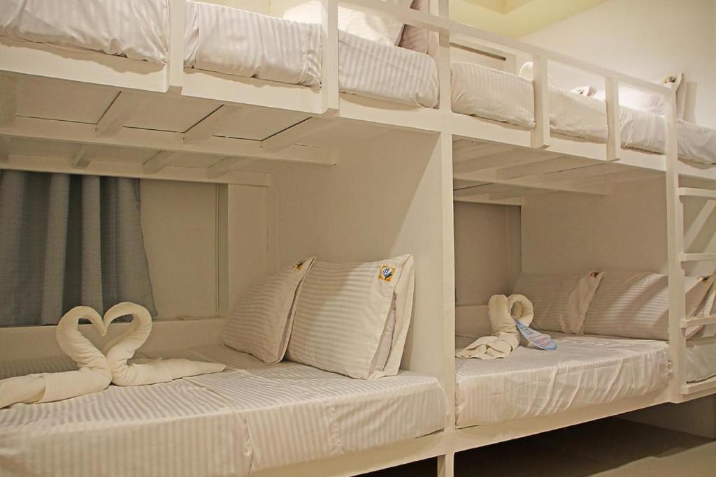 Postel nebo postele na pokoji v ubytování Layang Layang Home