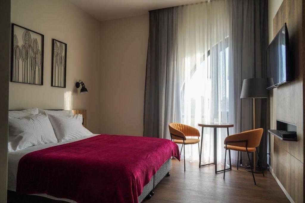 TV a/nebo společenská místnost v ubytování Apartique Hotel