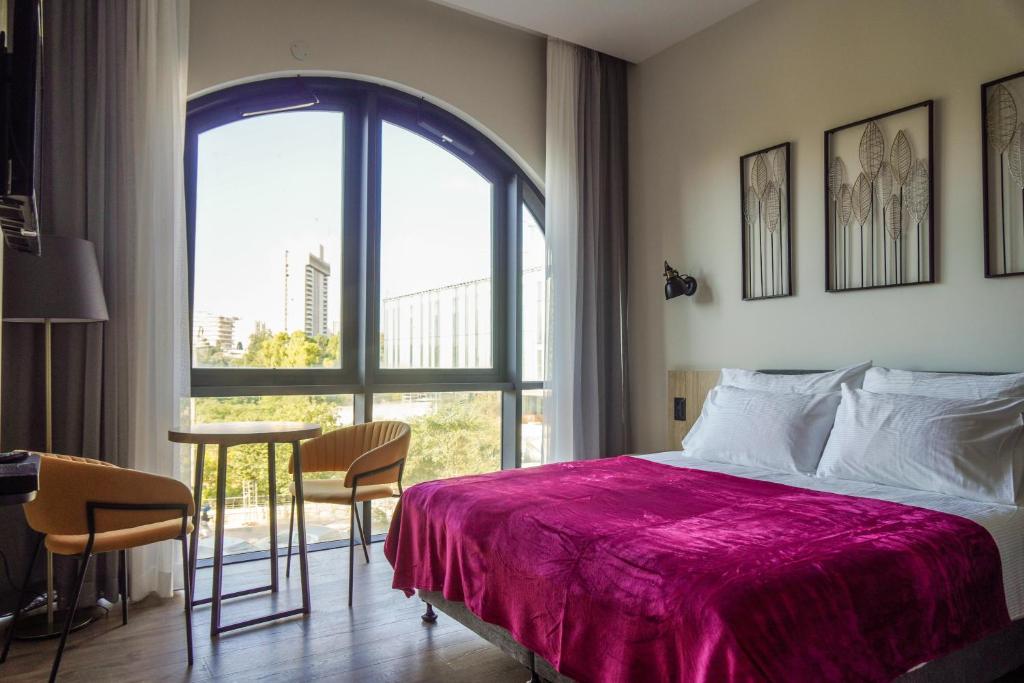 Postel nebo postele na pokoji v ubytování Apartique Hotel