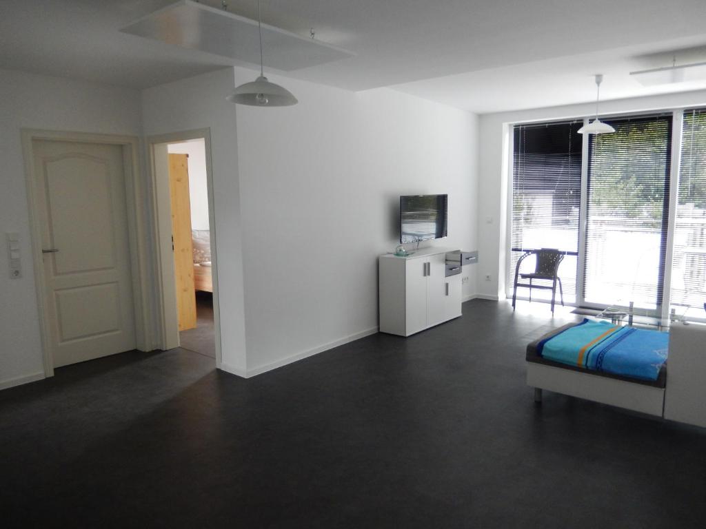 a room with a bed and a tv and a table at Haus Stadler in Irsch