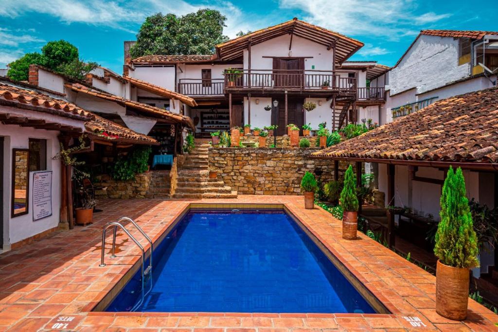 a house with a swimming pool in front of a house at La Serrana Hostal Spa in Socorro