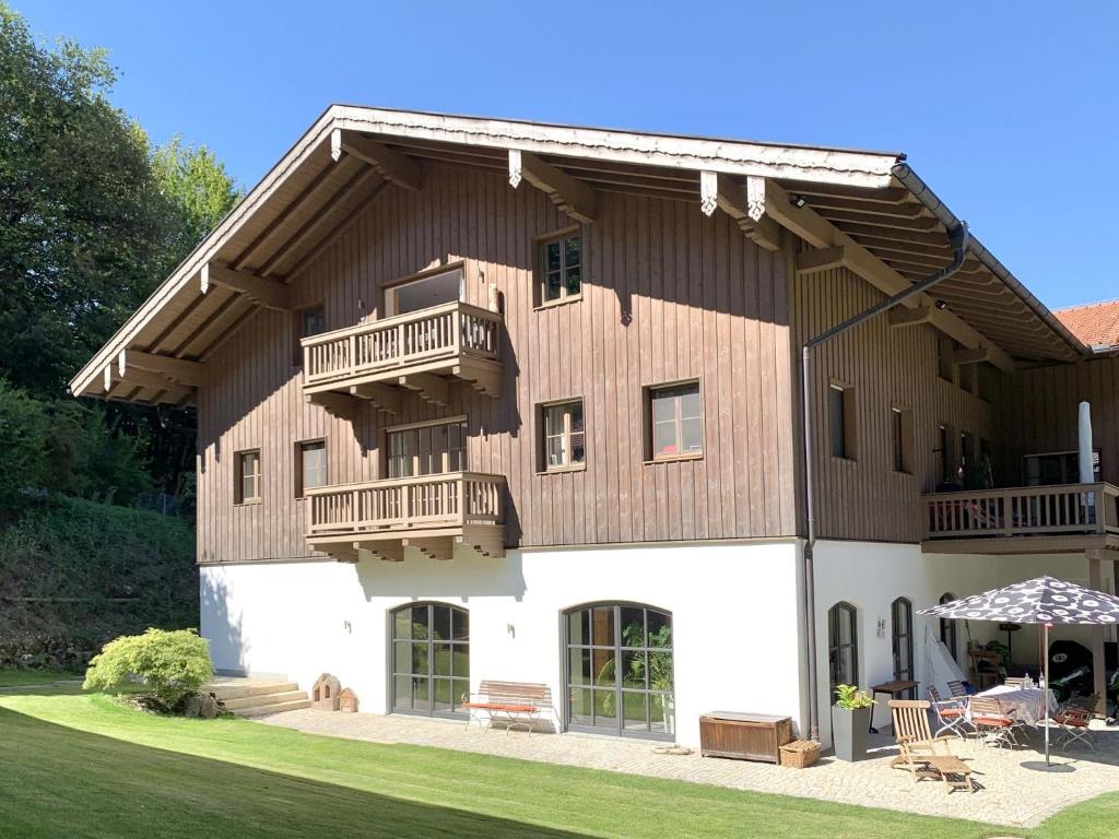 a large wooden house with two balconies on it at Auszeit im Chiemgau, Ferienwohnungen in Rottau