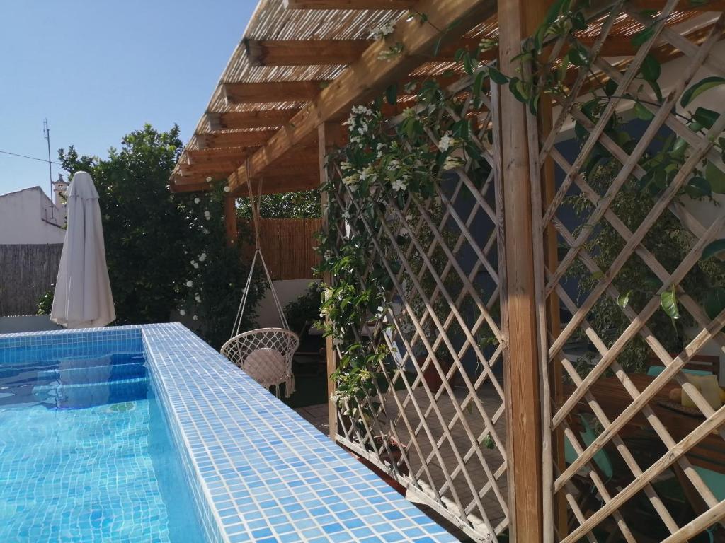 a patio with a swimming pool and a wooden fence at Casas de Sabóia in Sabóia