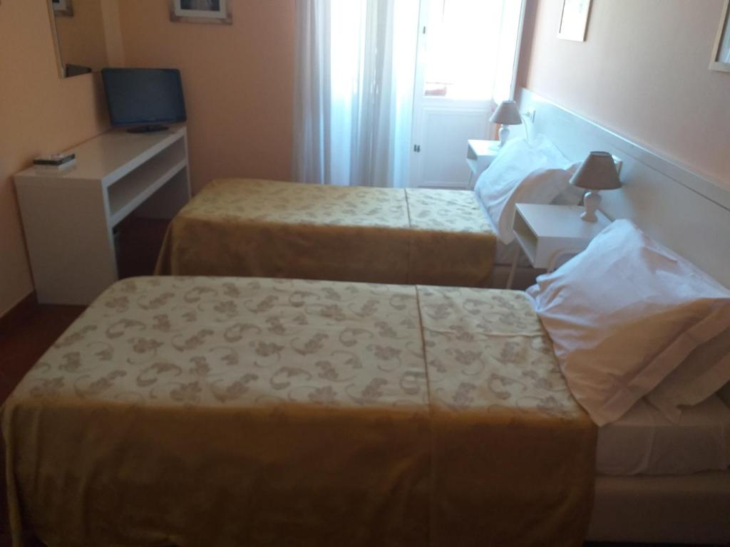 Postel nebo postele na pokoji v ubytování Hotel Monna Lisa