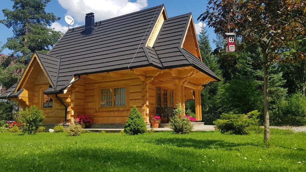 a log cabin with a gambrel roof at BIAŁY PUCH in Zakopane
