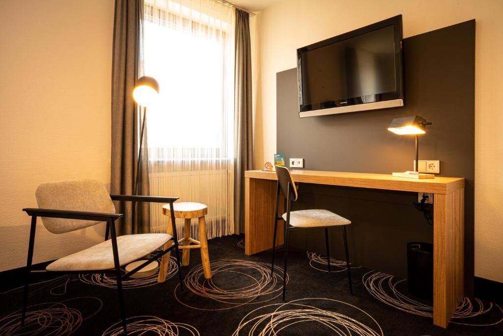 Televiisor ja/või meelelahutuskeskus majutusasutuses Hotel Rio
