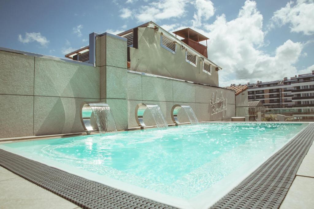 a swimming pool on the roof of a building at Zenit Convento San Martin in San Sebastián
