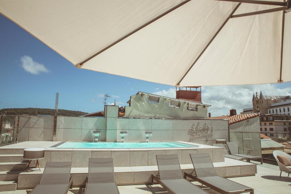 a swimming pool on the roof of a building at Zenit Convento San Martin in San Sebastián