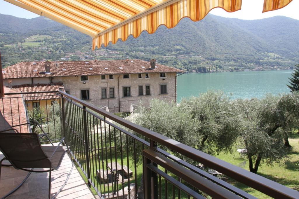 a balcony with a view of a building and a lake at La dimora dei pescatori in Monte Isola