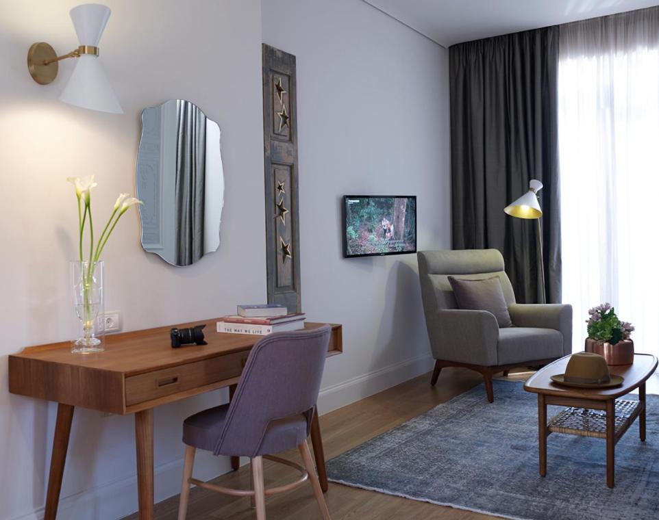 a living room with a desk and two chairs at Marpessa Hotel & Spa in Agrinion