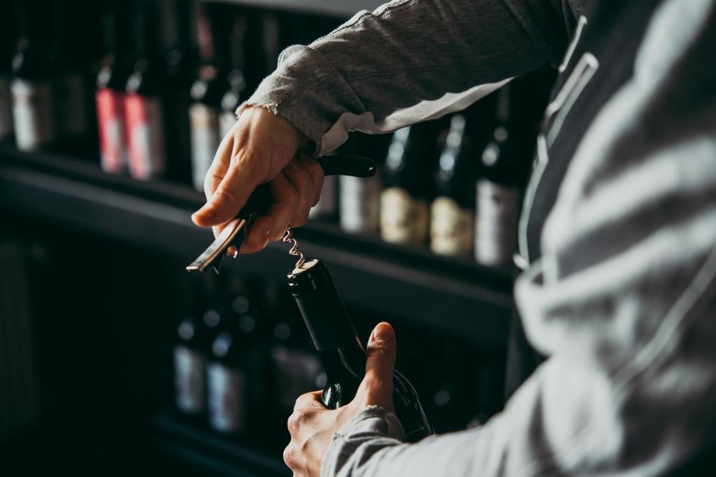 a man holding a wine glass in his hand at HAIDVOGL MAVIDA Zell am See in Zell am See