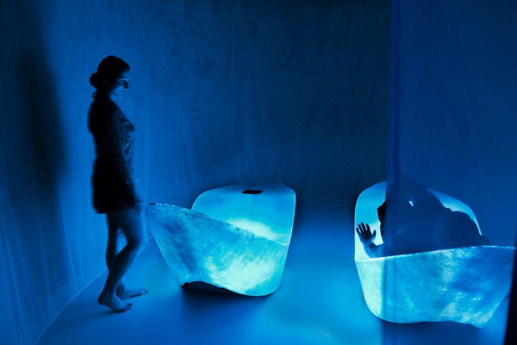 a woman walks past a sculpture of a iceberg at HAIDVOGL MAVIDA Zell am See in Zell am See