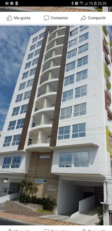 a large white apartment building with at Kattyapartament 303 Salinas in Salinas