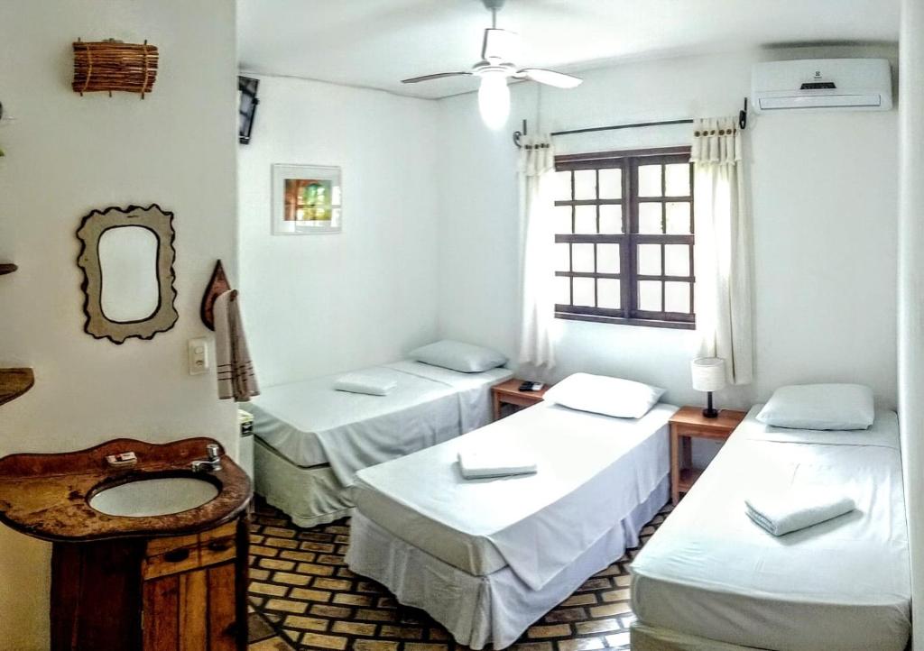 Cama ou camas em um quarto em Pousada Alto do Cajueiro