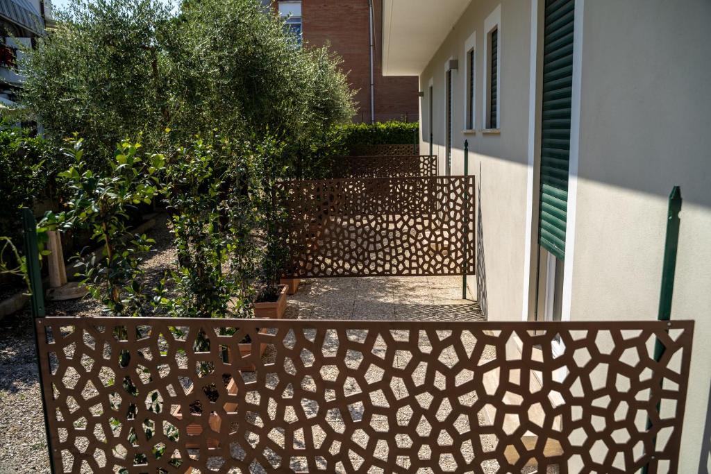 a wooden fence in front of a house at Gu Hotel in Guidonia
