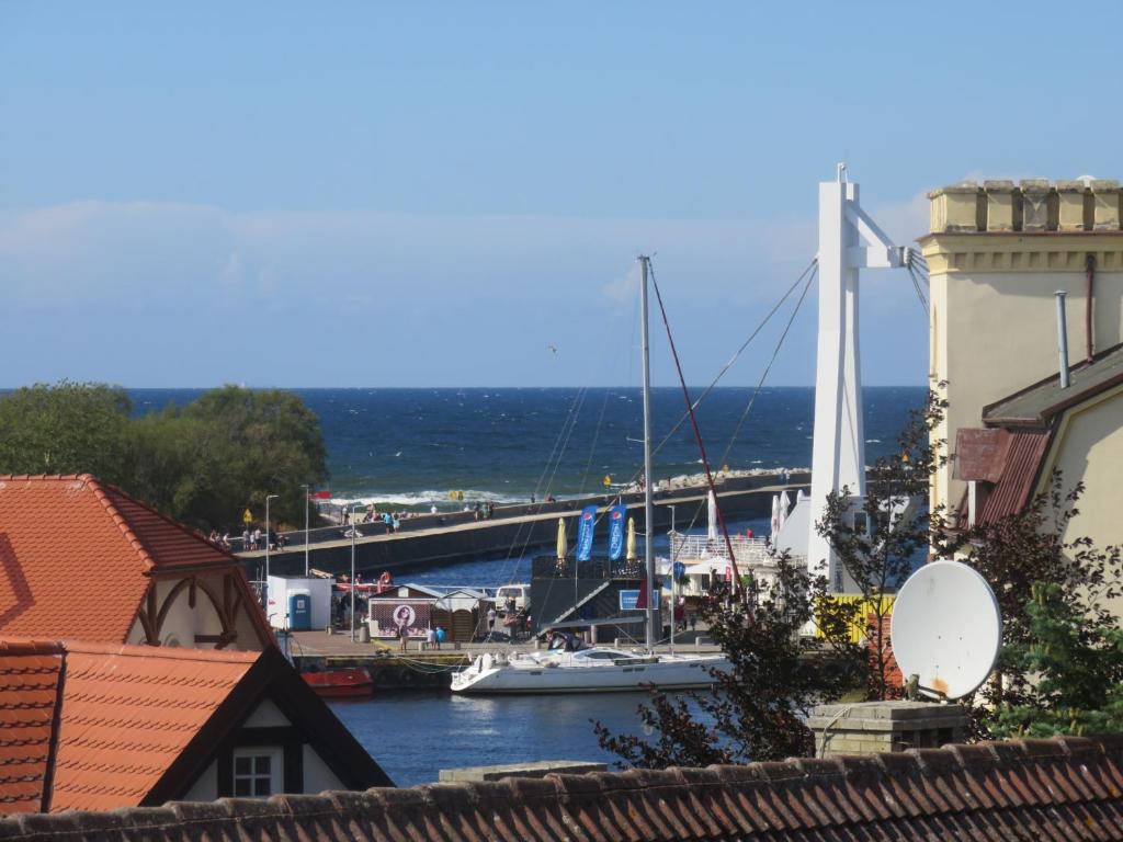 a view of a marina with boats and a bridge at BetulaAPART - Apartament z widokiem na morze in Ustka