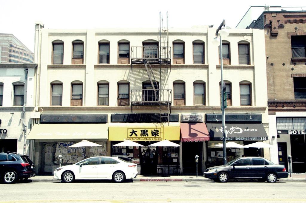 two cars parked in front of a building at Little Tokyo Hotel in Los Angeles