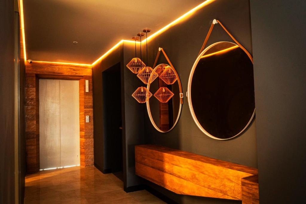 a bathroom with a surfboard hanging from the wall at HOTEL CAVALTA in Medellín