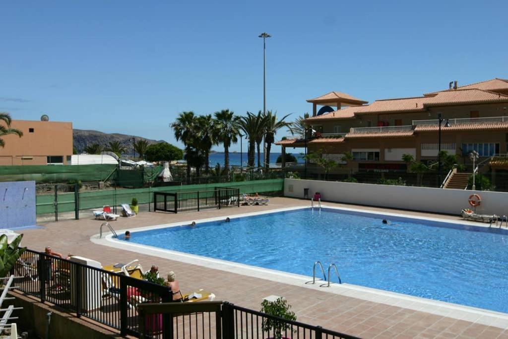 a large swimming pool next to a building at Nice studio Bart 50 meters from Playa Las Vistas in Arona
