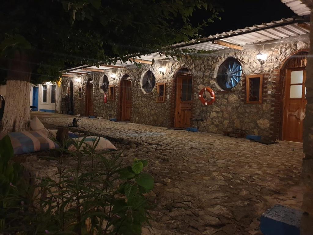 a stone house with lights on it at night at Zirkon Doğa Butik Otel in Fethiye
