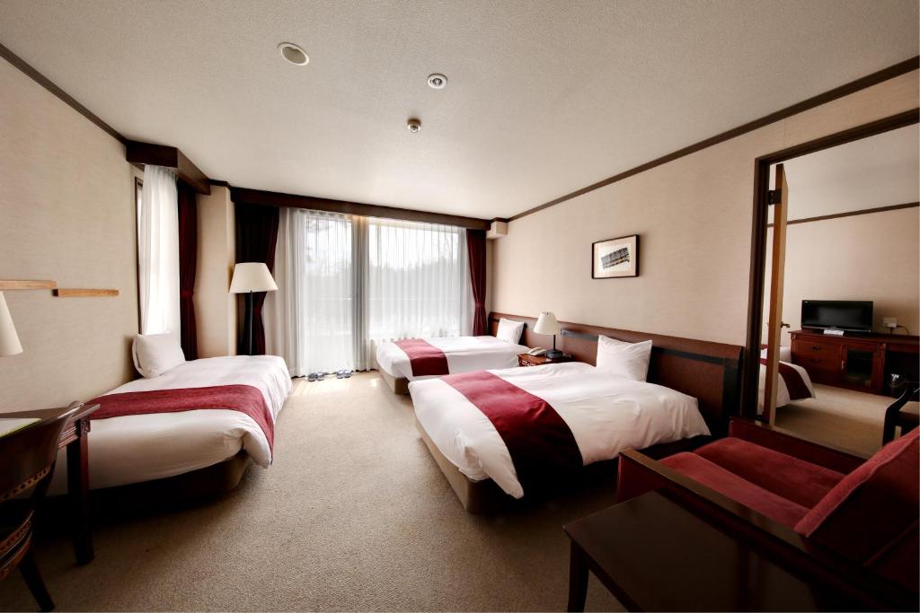 Postel nebo postele na pokoji v ubytování Hakuba Mominoki Hotel