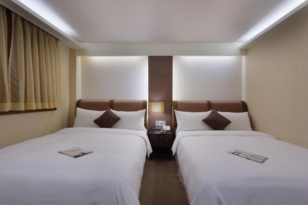 Postel nebo postele na pokoji v ubytování K Hotel Keelung