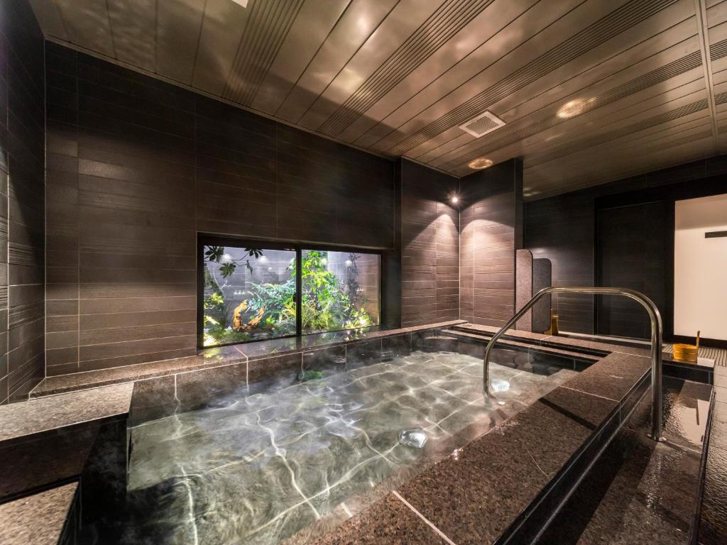 a bathroom with a large tub in the middle at Super Hotel Premier Kanazawaeki Higashiguchi in Kanazawa