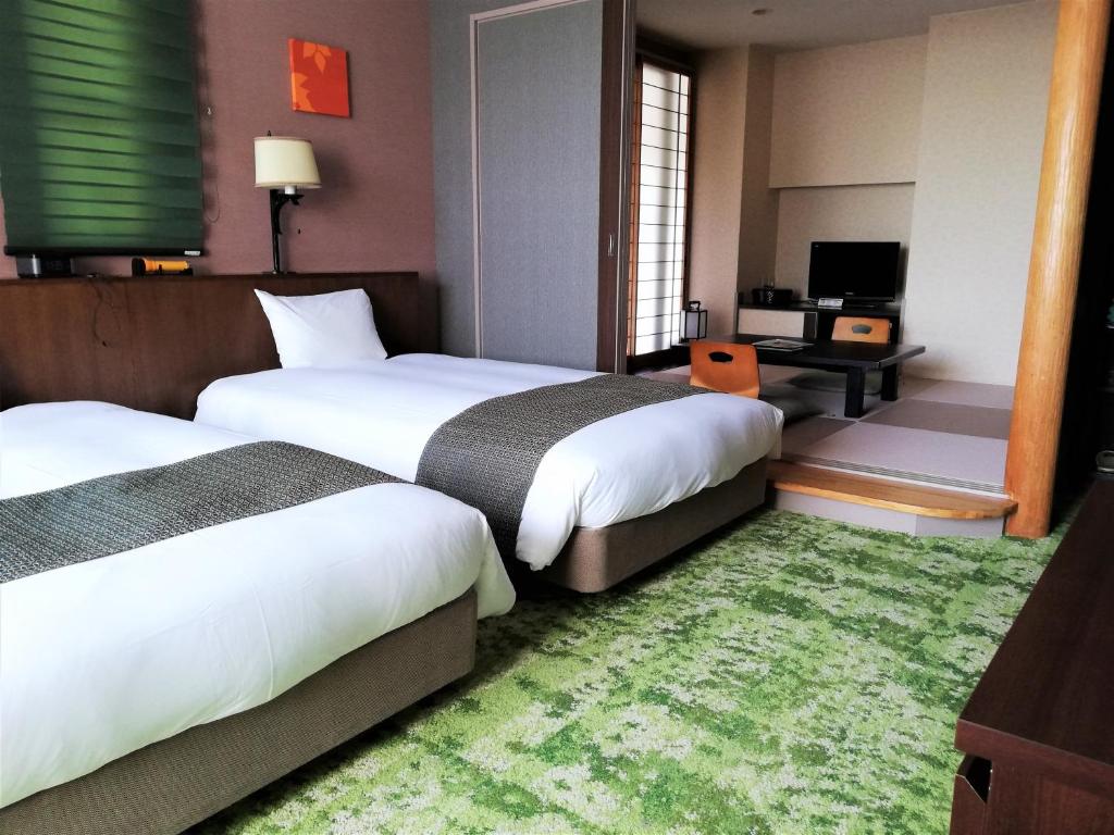 Postel nebo postele na pokoji v ubytování Hakuba Mominoki Hotel