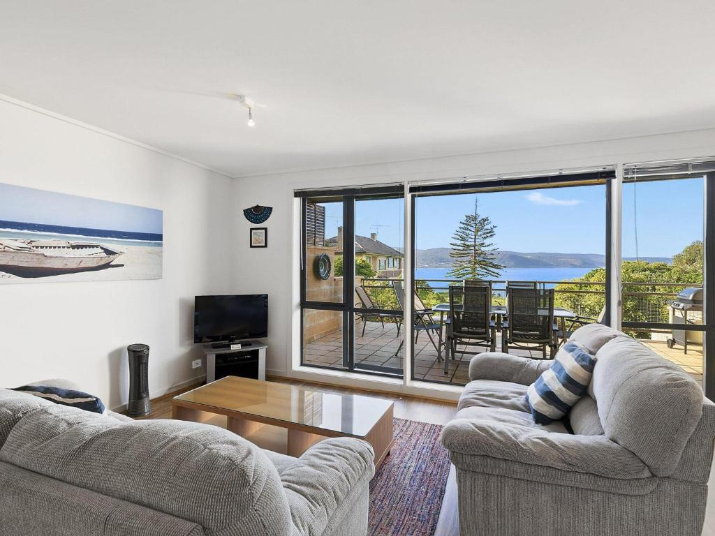 a living room with two couches and a view of the ocean at Apartment 26 Pacific Apartments in Lorne