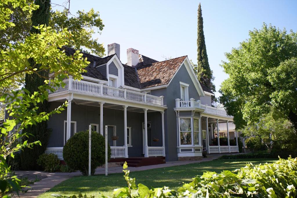 a large house with a wrap around porch at The Mulberry Inn -An Historic Bed and Breakfast in St. George