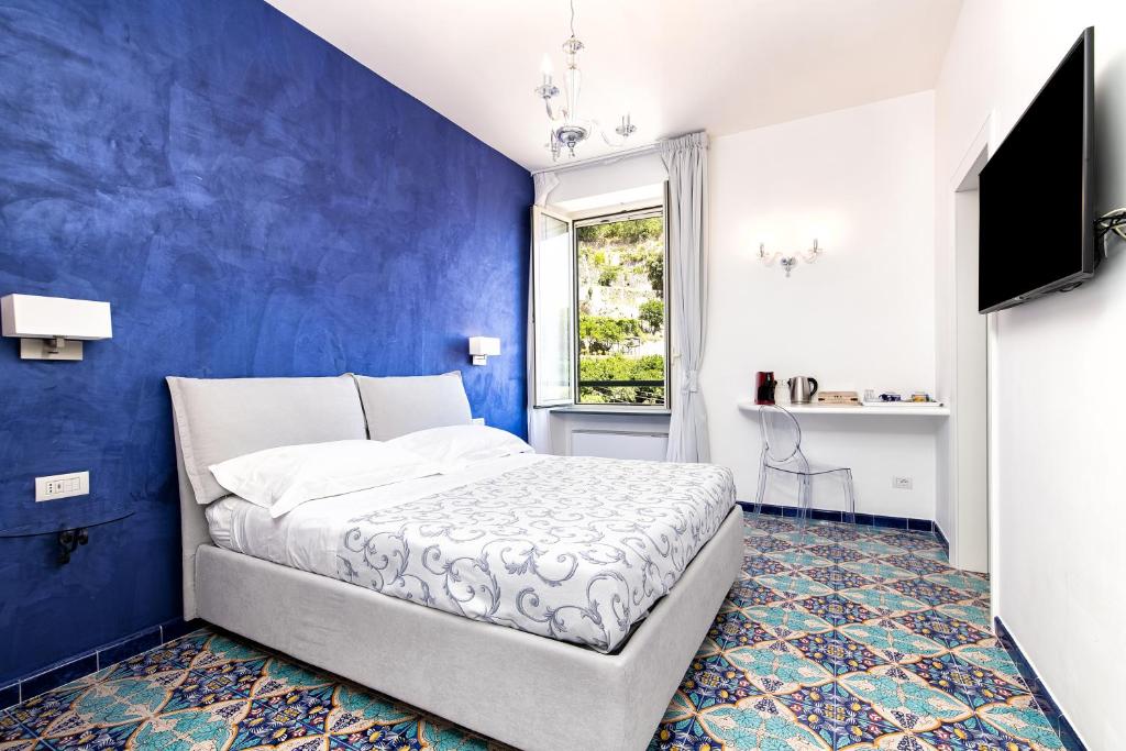 Postel nebo postele na pokoji v ubytování Valle d'Amalfi Suites