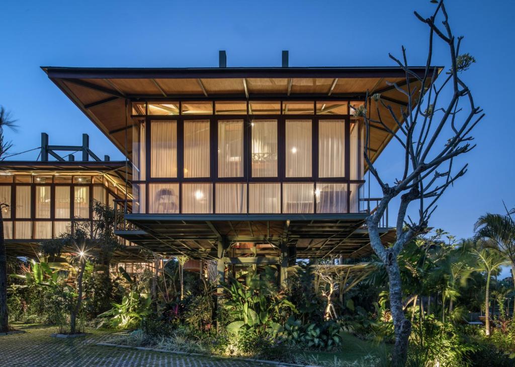 a house with a large glass facade at Grün Canggu Garden in Canggu