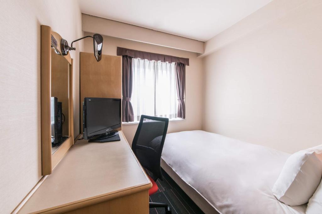 Postel nebo postele na pokoji v ubytování the b suidobashi