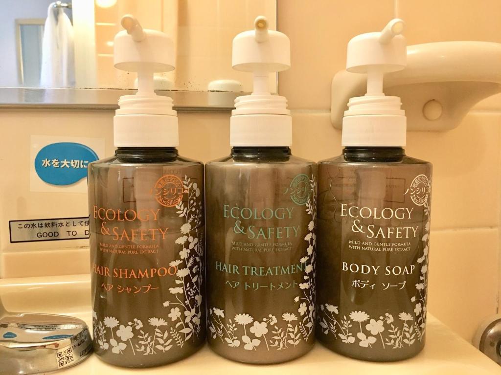 three bottles of soap on a counter in a bathroom at Hotel Fujita Fukui in Fukui