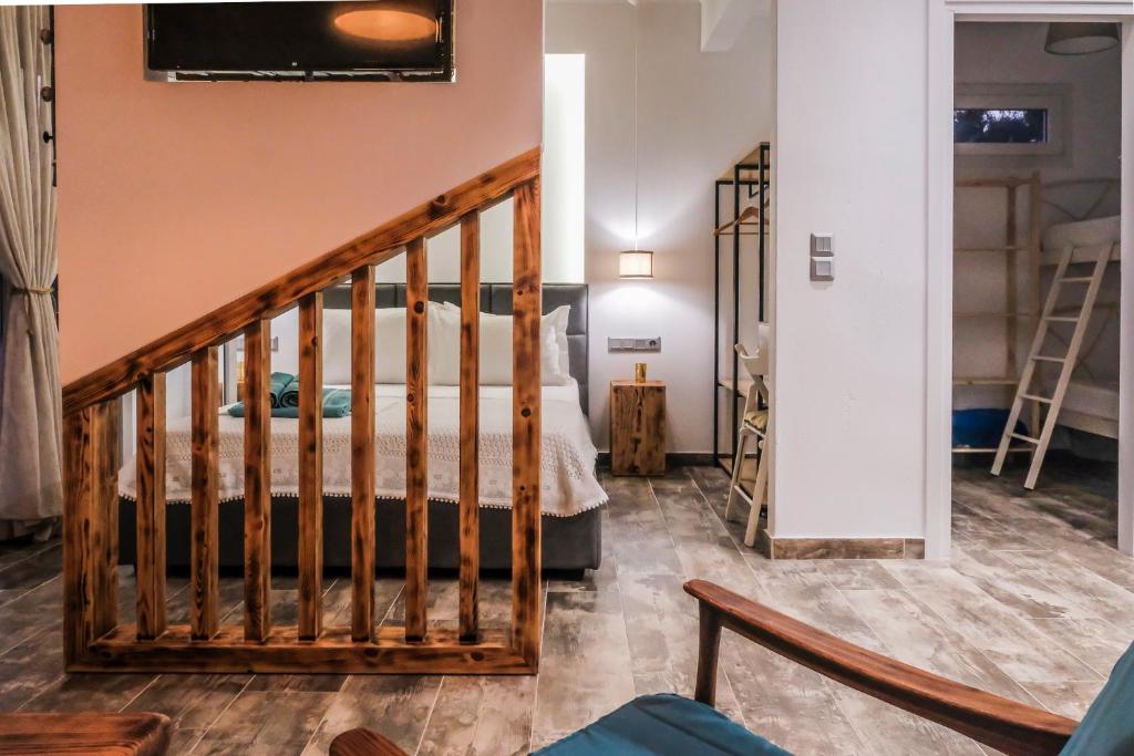 a staircase leading to a bedroom with a bed at Kartalia apartment in Porto Koufo