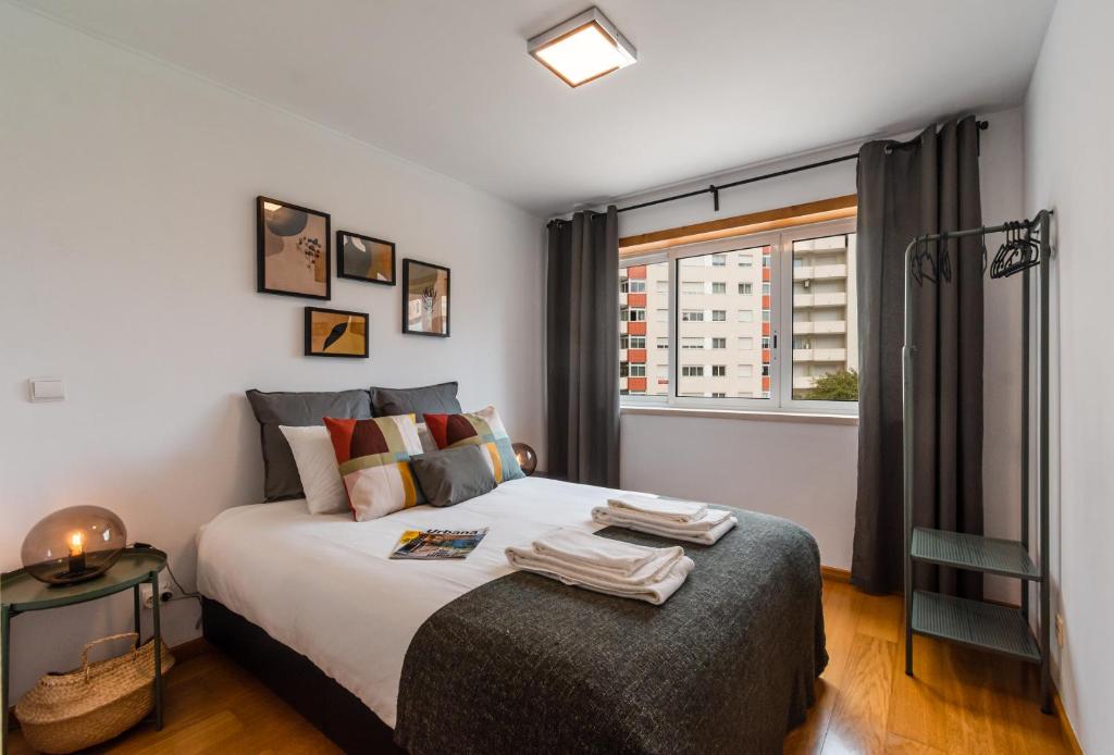 a bedroom with a large bed and a window at Conchas - 88214AL in Lisbon