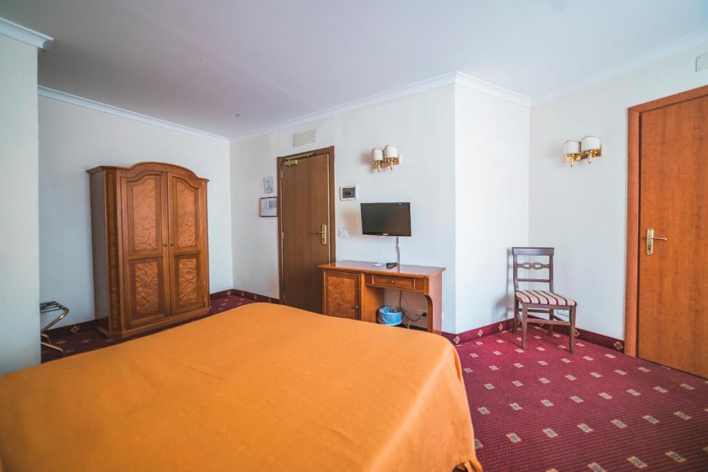 Postel nebo postele na pokoji v ubytování GH Hotel San Giusto